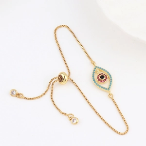 Detailed view of adjustable gold evil eye bracelet with colorful zircons and sliding clasp