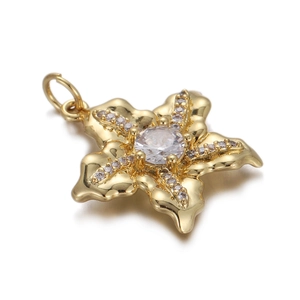 Macro shot of gold-plated cross flower pendant with sparkling clear zircon stones