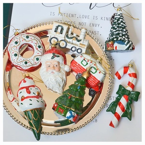 Assorted Christmas ornaments including Santa and candy cane in a decorative tray