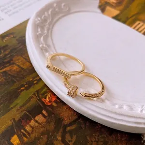 Luxurious gold-plated nail ring with pavé cubic zirconia and a sleek open geometric ring