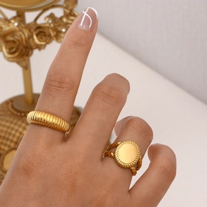 18K gold plated stainless steel oval seal and ribbed rings worn on a hand