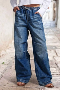 Detail of high waist drawstring and pocket on blue wide-leg street vintage denim jeans