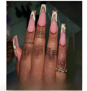 Detail of extra long square press-on nails with green and brown wave patterns