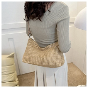 Close-up of a handmade straw tote bag with intricate woven hollow mesh texture