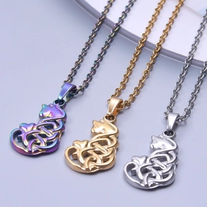 Detailed close-up of cat-shaped pendants with Celtic knot patterns in three metallic colors
