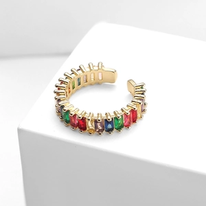 Macro shot of adjustable gold ring with multi-color rectangular zircon stones on white cubes