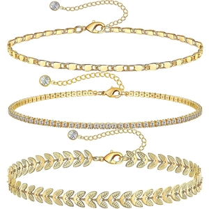 Detailed set of three gold-tone anklets featuring curb chain and leaf designs