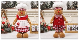 Detail view of plush gingerbread man dolls in festive red and brown Christmas outfits