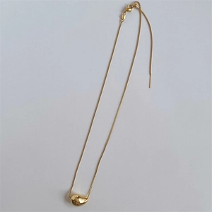 Detail of polished gold bean pendant on stainless steel box chain with lobster clasp