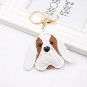 Brown and white PU leather Beagle dog keychain with golden hardware on a white background
