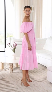 Detail of off-shoulder puff sleeves and elastic waist on pink floral midi dress