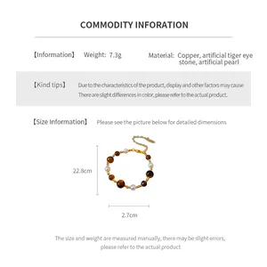 Detail view of gold-plated beaded bracelet with artificial tiger eye and pearls