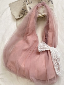 Pink mesh tote bag with large white lace bow in a stylish French romantic aesthetic