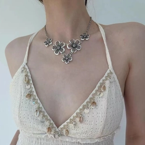 Bohemian silver floral necklace with vintage hollow flower design worn by a model