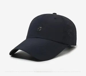 Detail view of laser-perforated S logo for breathability on navy outdoor baseball cap