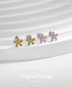 Detailed macro of S925 silver flower earrings with yellow and pink enamel petals