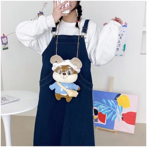 Cute Shiba Inu plush crossbody bag with glasses and blue sweater shown on a model