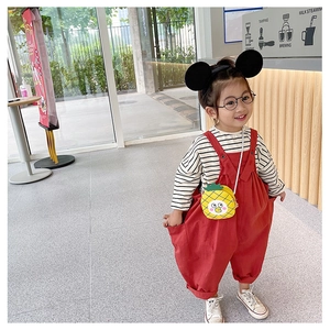 Detail of cute yellow pineapple shaped crossbody bag for little girls fashion accessories