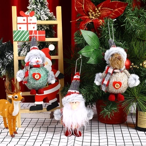 Detail of plush Christmas tree ornaments featuring snowman, elk, and Santa Claus