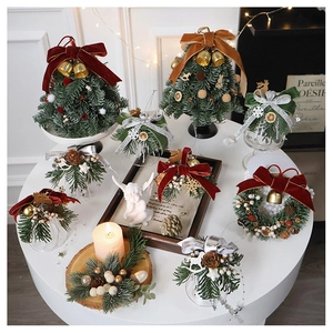 Detail of Christmas decoration set with mini tree, metal bells and natural pine cones