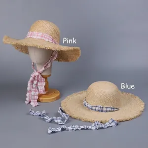 Wide brim raffia sun hat for women with sweet ribbon ties and fringe detail