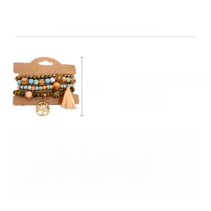 Detail of bohemian sandalwood beaded bracelet with tree of life charm and pink tassel
