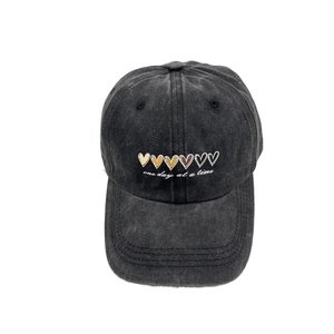Washed charcoal baseball cap with heart patterns and one day at a time slogan