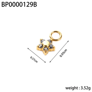 Detail of gold star pendant with black zircon inlays and dimensions of 0.93cm x 0.57cm