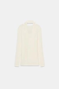 Detail of a creamy white long sleeve top with a unique cutout scarf neckline design