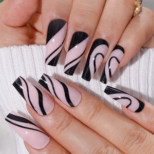 Long ballet press-on nails featuring a pink base and black streamlined wave patterns