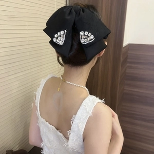 Large black fabric bow hair claw with rhinestone trim for women's thick hair styling