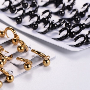 Polished stainless steel hoop earrings with hanging metal beads in gold and black