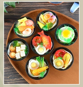 Detailed overhead view of 7 miniature Japanese ramen bowls with realistic food toppings