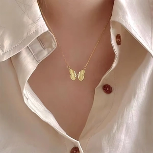 Elegant 18K gold plated butterfly pendant necklace with zircons on silk background