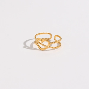 Detailed close-up of golden hollow heart ring with double-layered beaded band design