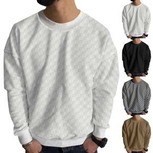Detail of waffle knit jacquard texture and crewneck on men's long sleeve sweater