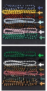 Macro detail of various colorful natural stone 6mm bead rosaries with cross pendants