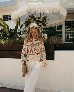 Detail of beige crochet hollow out top with spiral texture for beach vacation style