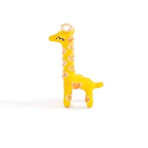 Detail of yellow giraffe enamel pendant with orange hearts and metal hanging loop