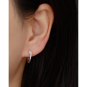 Close-up of elegant S925 sterling silver huggie earrings with micro-set zircon on model