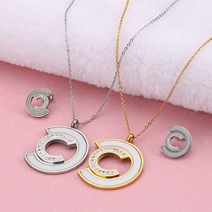 Exaggerated C-shaped stainless steel necklace and earrings set with shell inlay and diamonds