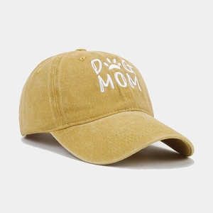 Close-up of white Dog Mom embroidery and paw print on washed cotton baseball cap