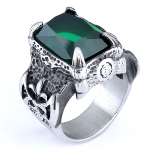 Detailed close-up of emerald-cut green stone on vintage silver-tone ring band