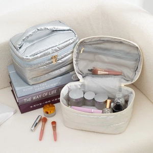 Detailed macro view showing the quilted texture and large capacity of pearlized makeup bags