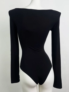Detail of black long sleeve bodysuit showing slim fit cotton fabric and U-neckline