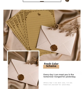 Close-up of vintage linen envelope with golden wax seal and rabbit floral letter paper