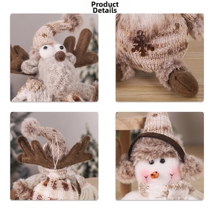 Detail of knitted Christmas reindeer and snowman hanging ornaments with snowflake embroidery