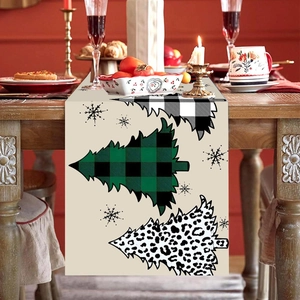 Christmas table runner with plaid and leopard tree patterns on a festive dining table