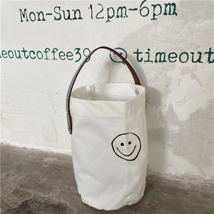 French vintage polka dot canvas bucket bag with brown leather handle and smiley face design