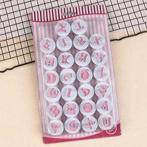 Set of 26 uppercase alphabet cookie stamps in pink and white retail packaging